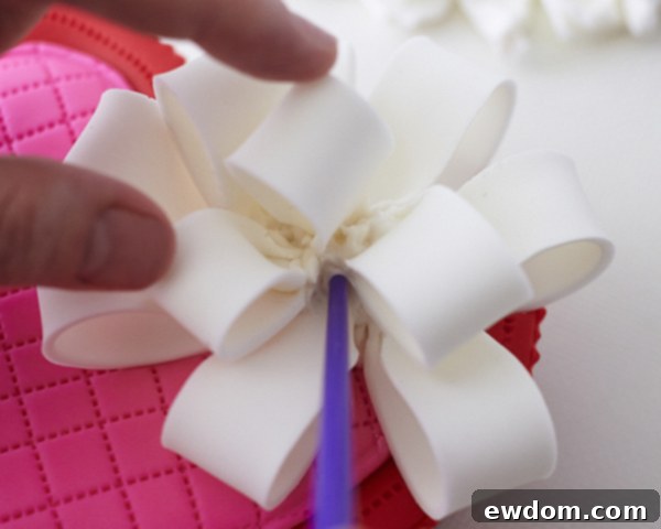 Valentines Candy Heart Surprise Cake 39 Finishing the fondant bow by tucking in excess fondant with a paintbrush