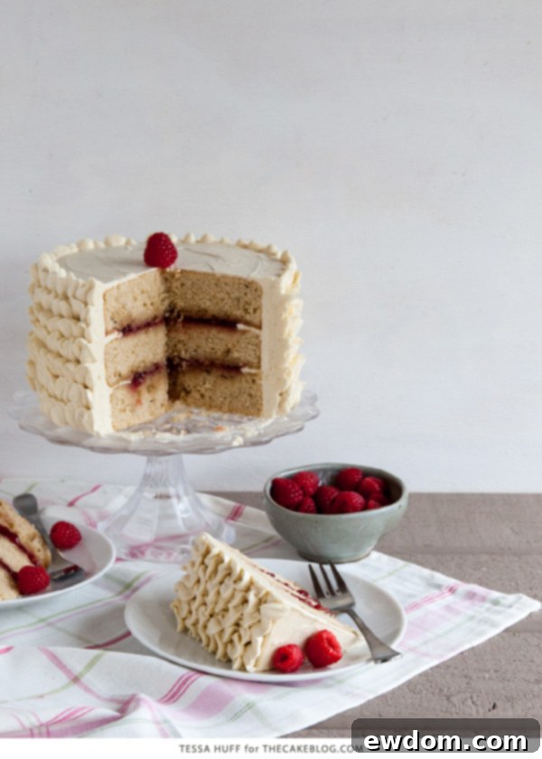 A close-up of Raspberry Earl Grey Cake slice showing layers