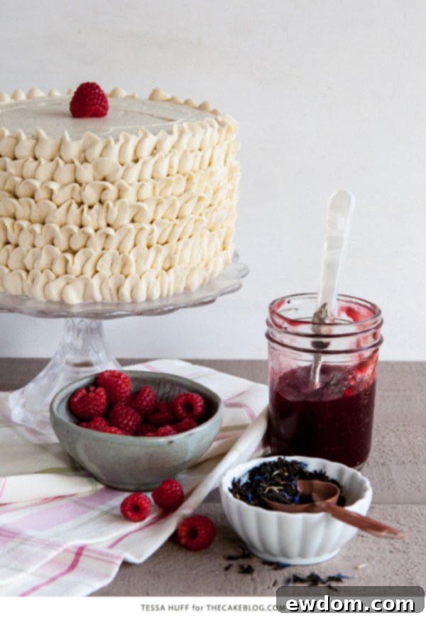 Close-up of a stacked Raspberry Earl Grey Cake with buttercream frosting