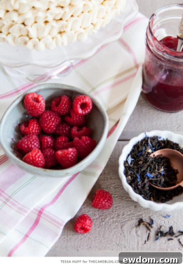 Side view of a Raspberry Earl Grey Cake slice on a plate