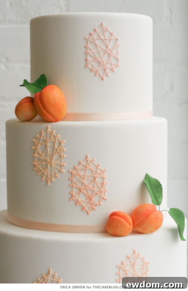 Artfully arranged modeling chocolate apricots complementing the geometric royal icing patterns on the wedding cake.