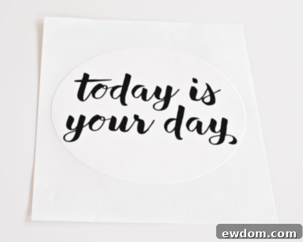 Applying the PhotoCake® Edible Cake Image to the top of the frosted DIY sprinkle cake, creating easy edible writing for Graduation Party Desserts.