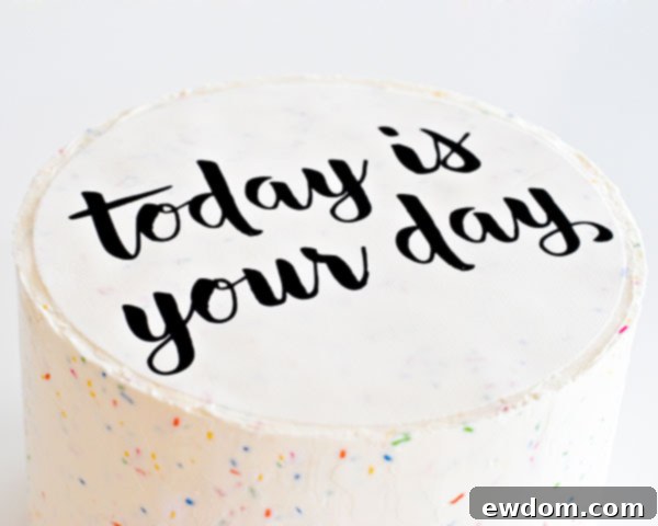 Carefully pressing down the edible image onto the cake, ensuring a smooth and seamless application for this stunning Graduation Party Dessert.