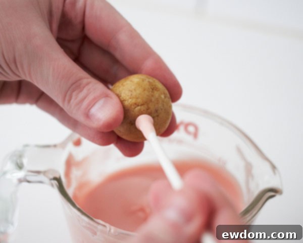 Dip sucker stick into coating, insert into large cake ball, then dip entire ball.