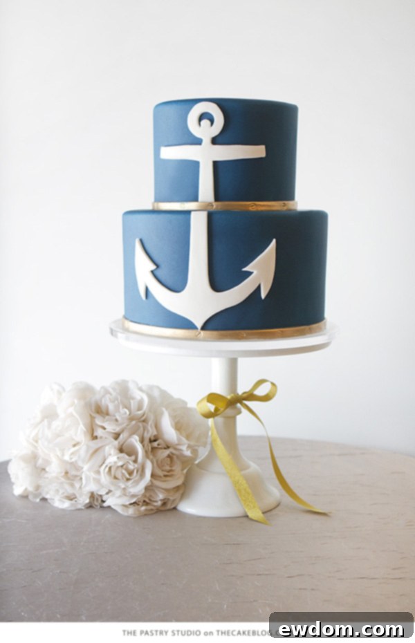 Modern navy nautical wedding cake with crisp white anchor and gold bands by The Pastry Studio