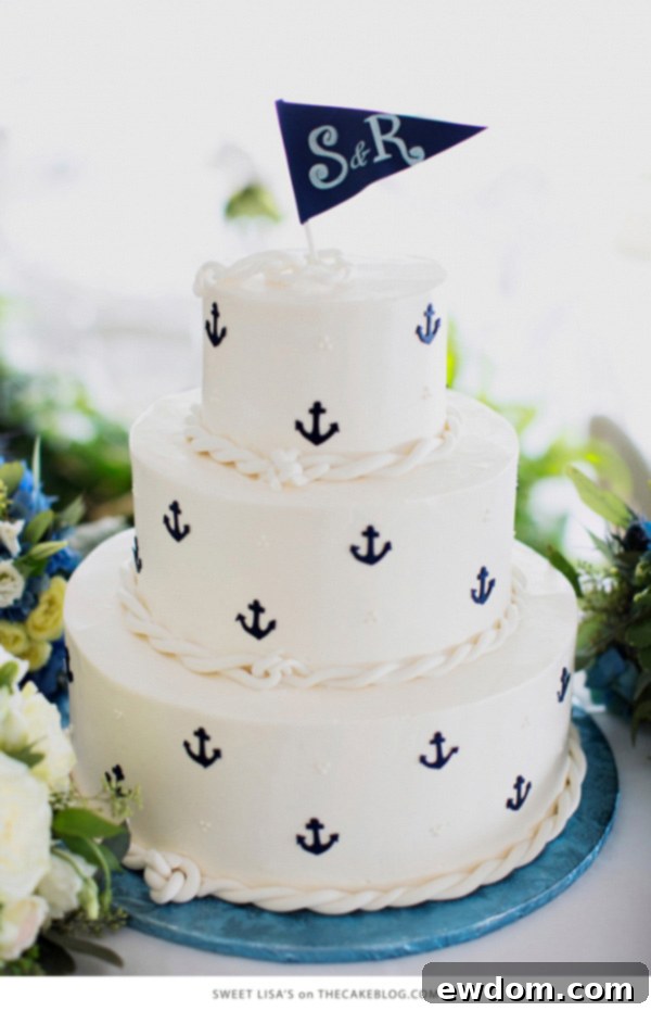 Classic buttercream nautical cake with navy anchors, swiss dots, and monogram flag by Sweet Lisa's