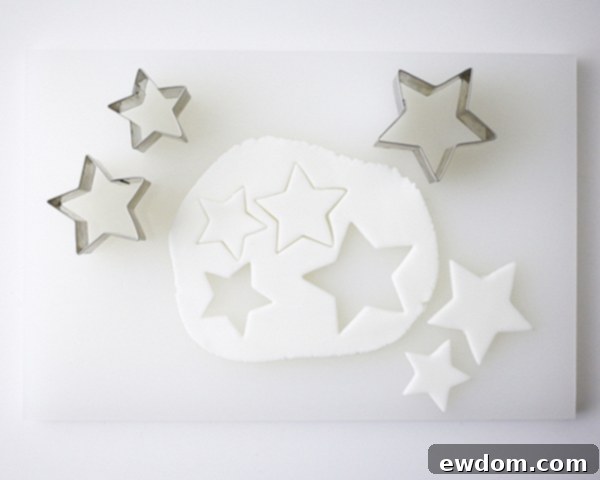 Rolling out gumpaste and cutting star shapes for DIY cake toppers | by Cakegirls for TheCakeBlog.com