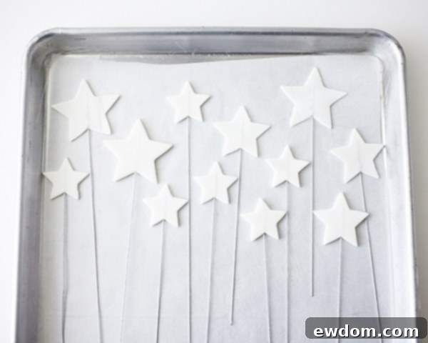 Gumpaste stars on wire drying on parchment paper before glitter application | by Cakegirls for TheCakeBlog.com