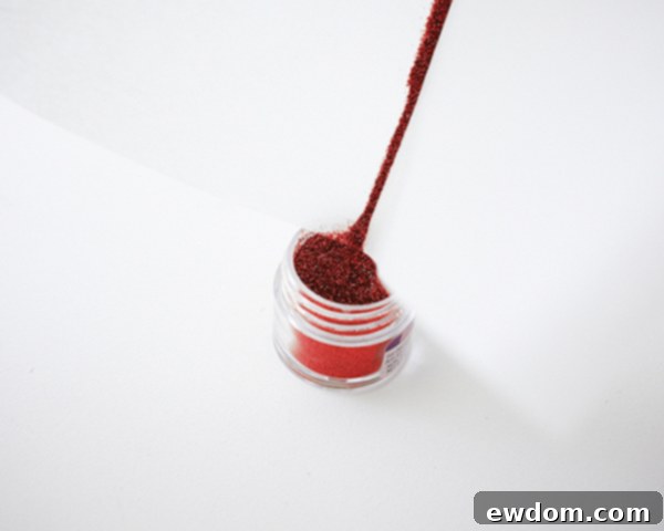 Funneling excess disco dust back into its container after applying to cake toppers | by Cakegirls for TheCakeBlog.com