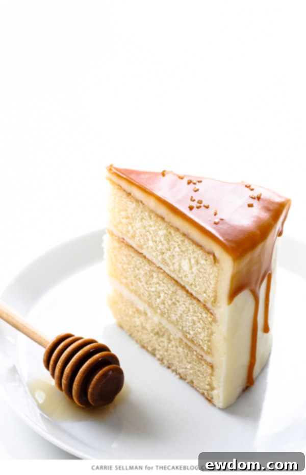 Detailed shot of the Honey Butter Cake's interior, revealing the three golden layers of cake and generous honey cream cheese frosting.