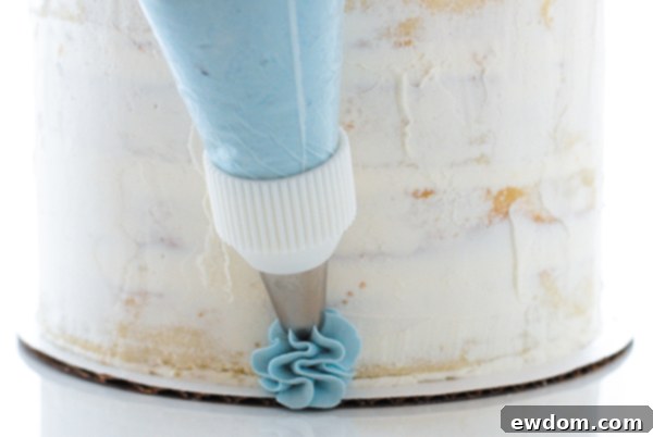 Continuing the upward motion while piping elegant buttercream ruffles