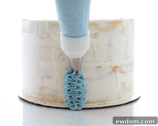 Completed vertical row of delicate buttercream ruffles on the Cinderella cake