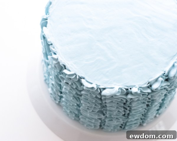 Cake fully covered with buttercream ruffles, top smoothed for decoration