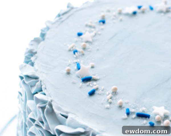 Decorating the top of the Cinderella cake with sprinkles and stars