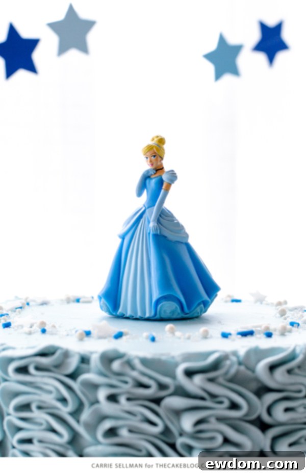 Top view of Cinderella cake with princess topper and sparkling sprinkles