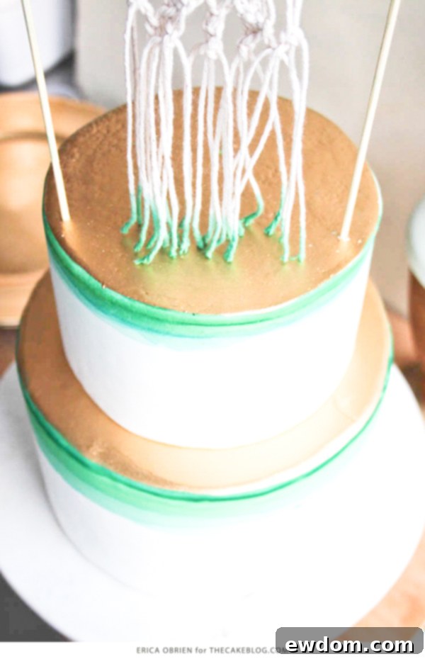 Gradient Macramé Masterpiece 5 The finished modern macrame cake by Erica OBrien with green dip-dye and elegant gold accents, perfect for bohemian chic events.