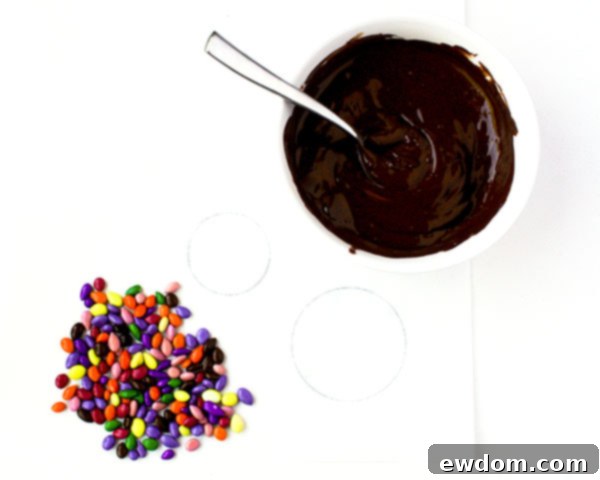 Preparing for chocolate sunflower seed medallions: drawing circles on parchment paper and melting high-quality chocolate