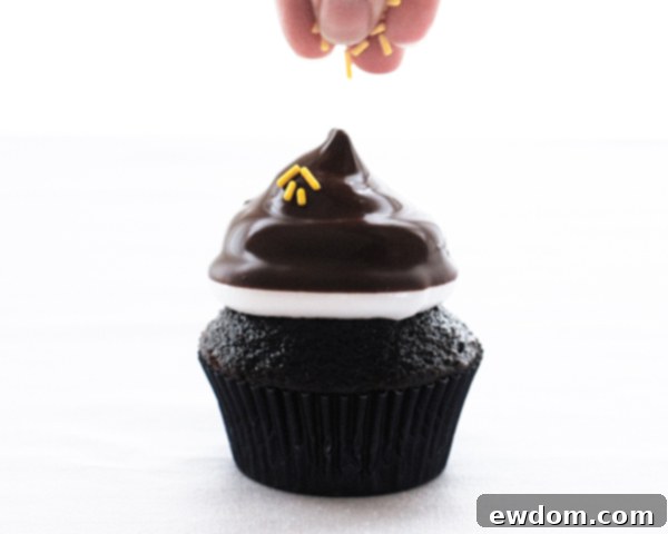 Touchdown Treat Cupcakes 17 NFL Game Day Cupcakes | chocolate cupcakes with fluffy marshmallow frosting and dipped in chocolate. Perfect for football tailgating and homegating.