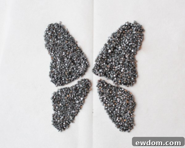 Removing excess silver sanding sugar from hardened candy melt butterfly wings