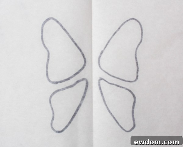 Flipping parchment paper with butterfly templates to prevent ink transfer