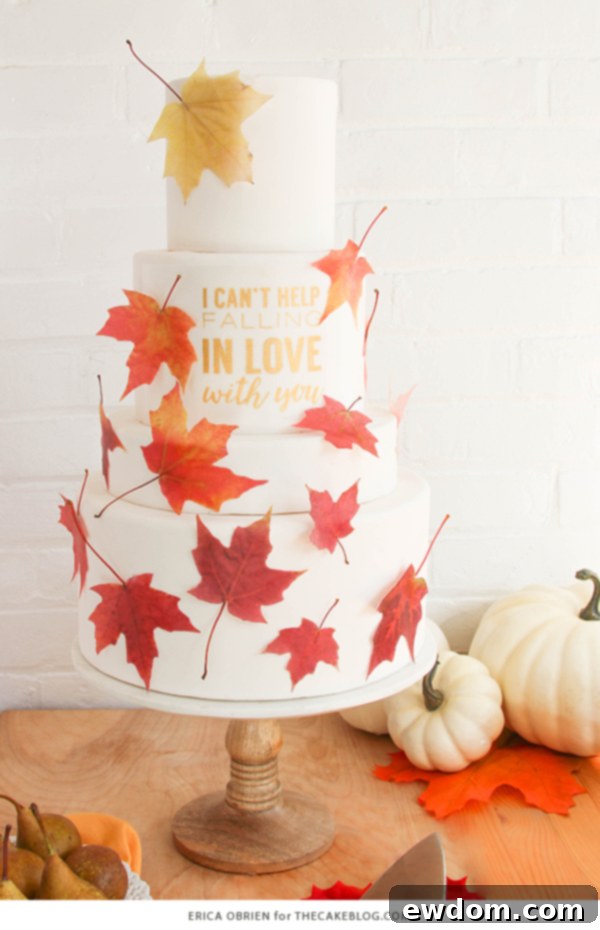 Falling in Love Autumn Wedding Cake by Erica OBrien featuring realistic wafer paper leaves and a hand-painted gold quote