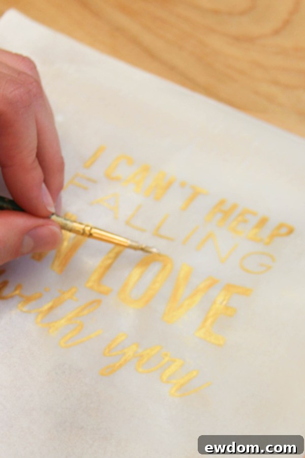 Modern chic wedding cake with a hand-painted gold quote 'I Can’t Help Falling in Love with You' on wafer paper