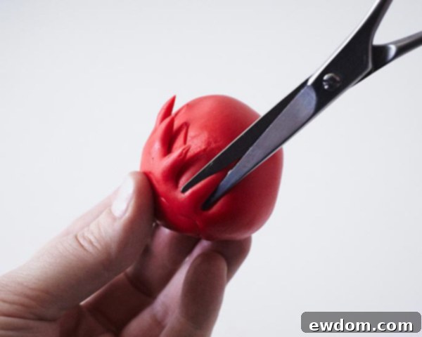 Rolling fondant into a ball for the pom-pom