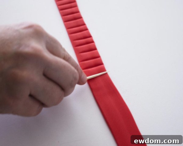 Adding textured indentations to the fondant hat band with a toothpick