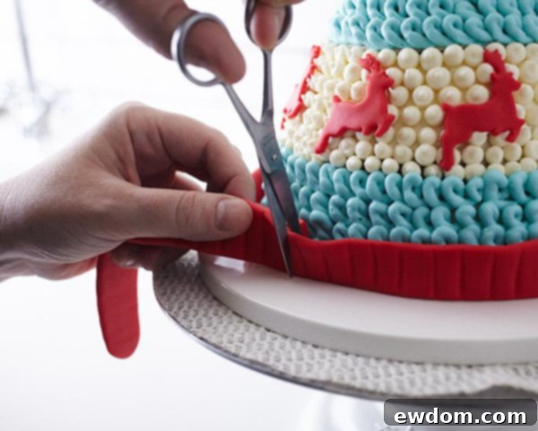 Carefully pressing the fondant band onto the cake for a neat finish