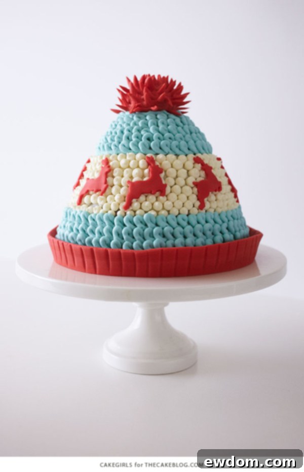 Beautifully decorated Winter Hat Cake with red fondant reindeer and pom-pom