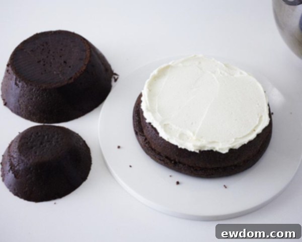 Applying buttercream filling between cake layers