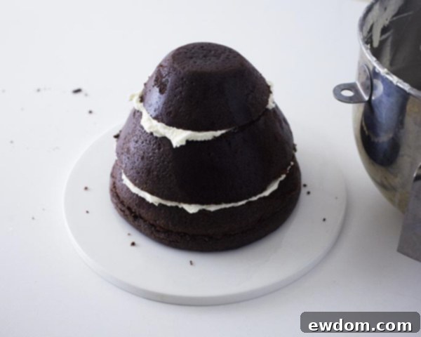 Applying the essential crumb coat to seal cake crumbs