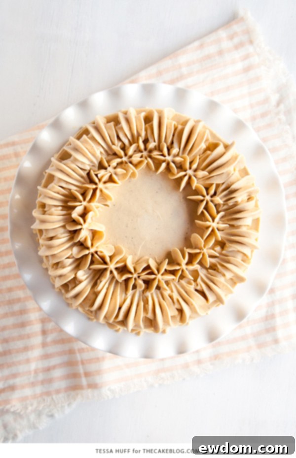 Moist layers of Maple Pear Cake featuring a creamy Maple Spice Buttercream and elegant piping details