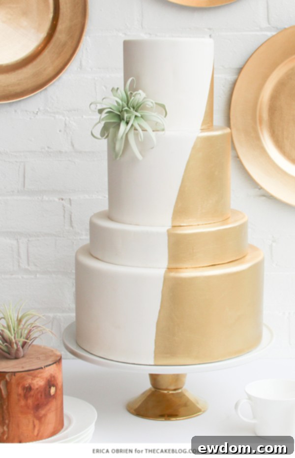 Detailed shot of the gold dipped wedding cake, highlighting the seamless transition between gold and white, a signature of Erica O'Brien's technique.