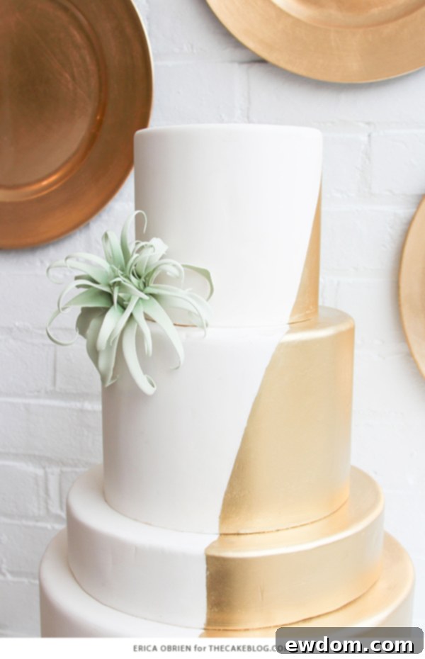 Close-up of the gold dipped wedding cake, showcasing the intricate gumpaste airplant detail, a modern botanical accent.