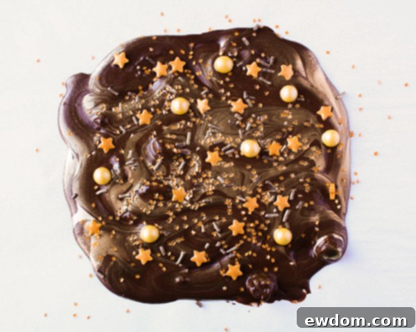 Breaking hardened chocolate into decorative shards for a drippy cake, by Erin Gardner