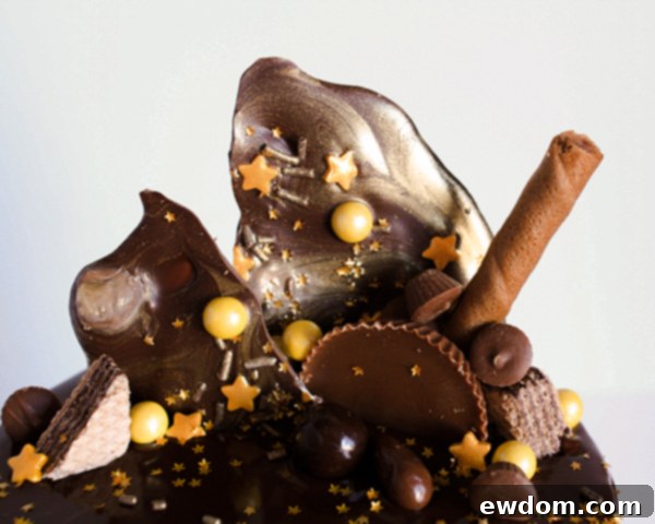 Arranging larger candy pieces and cookies on a drippy chocolate cake, by Erin Gardner