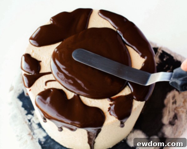 Tapping the cake stand to settle ganache and create natural drips on a chocolate cake, by Erin Gardner