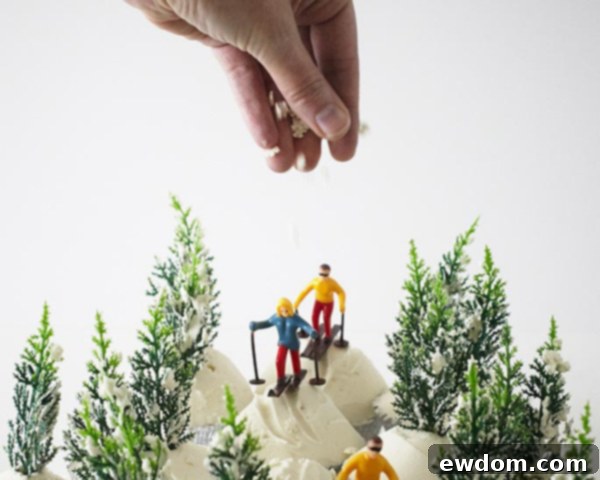 Edible snowflake confetti being sprinkled over the entire Ski Scene Cupcakes display for a sparkling finish.