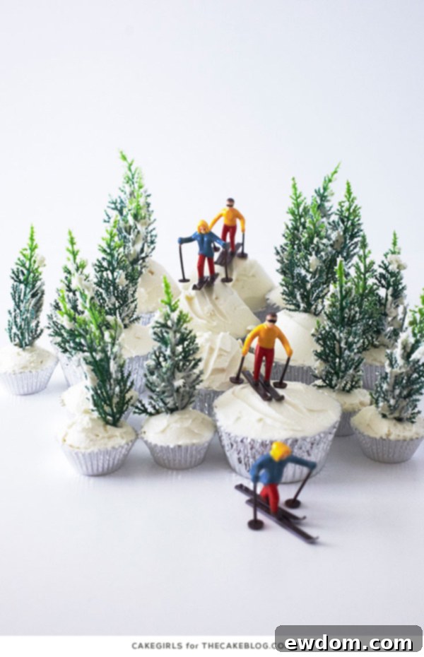 Detailed shot of the Ski Scene Cupcakes, focusing on a miniature skier traversing a buttercream-iced slope.