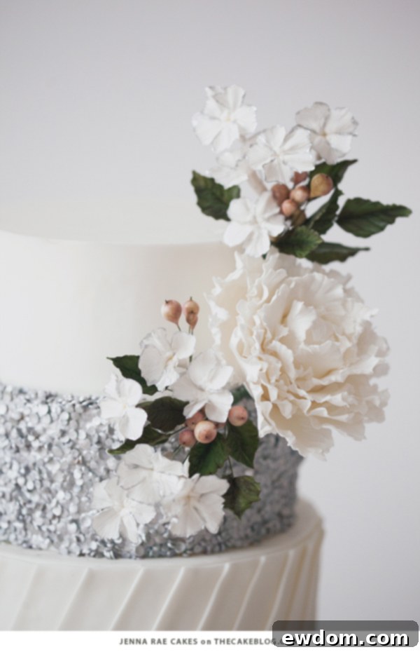 Glamorous White Fondant Cake with Silver Sequins and White Blooms by Jenna Rae Cakes | TheCakeBlog.com