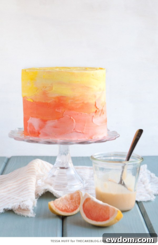 Pink Grapefruit Cake. A light olive oil cake filled with grapefruit curd and frosted with whipped vanilla buttercream - perfect for spring brunches, showers and birthdays | by Tessa Huff for TheCakeBlog.com