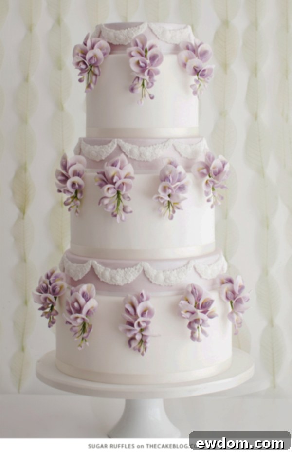 Sugar Ruffles: Delicate Spring Cake with Hanging Wisteria Sugar Flowers and Lace Appliqués