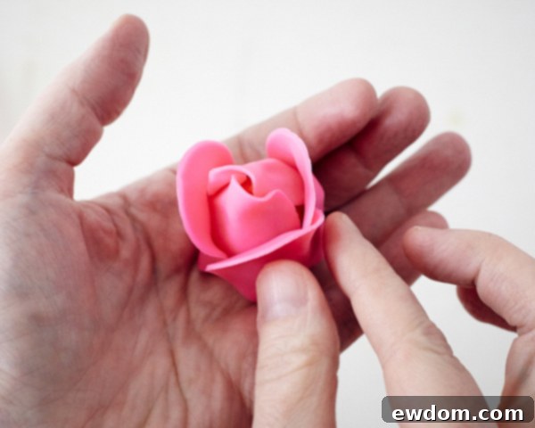 Blossom Cake Pops 19 Rose cake pop propped in a glass to dry, maintaining its delicate petal shape.