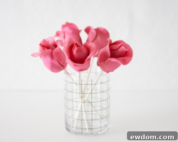 Blossom Cake Pops 21 Brushing off excess luster dust from the rose cake pop onto parchment paper.