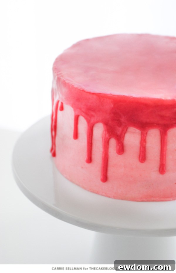 Pink Champagne Raspberry Dream 4 Detailed shot of the Raspberry Champagne Cake with a perfect pink drip glaze flowing down its sides, adorned with fresh raspberries.