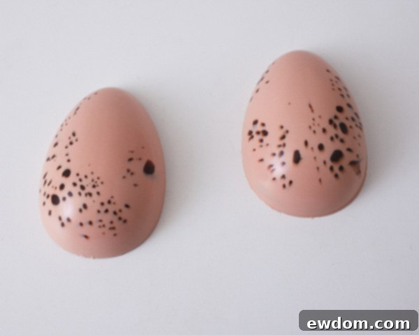 Step 6: Flexing the mold to carefully remove the hardened egg shells.