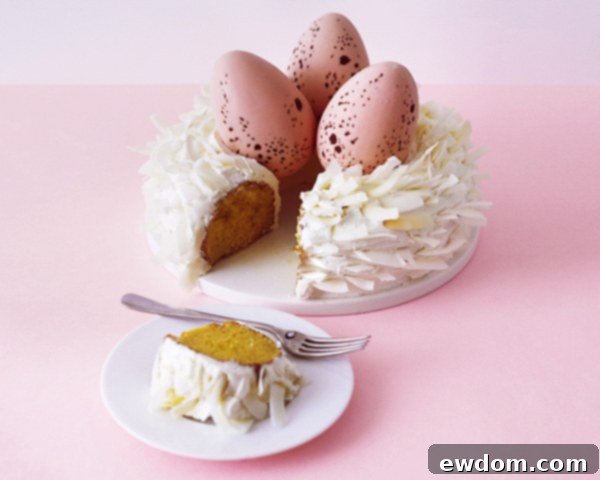 The finished Easter Nest Cake, a beautiful dessert centerpiece with roasted coconut and chocolate eggs.