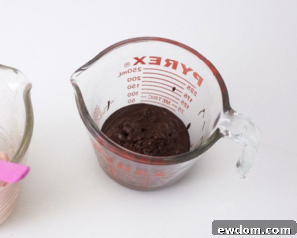 Step 2: Dipping a toothpick in melted chocolate to create speckles inside the egg mold.