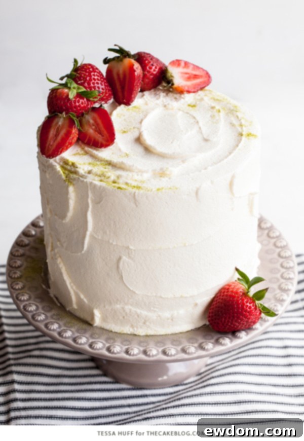 Strawberry Matcha Delight 6 Matcha Strawberry Cake from a top-down view, garnished with fresh strawberries and a dusting of matcha powder.
